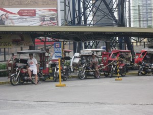 Filipino tricycles parked at a Manila terminal, awaiting fares. 
