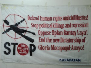 Banner denouncing political killings.