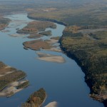 The Athabasca River flows north through the boreal forest north of Fort MacMurray.