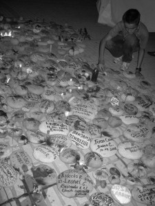 Stones with names at an August 2010 vigil against militarization and war in Colombia: These rocks represent missing and murdered community members in Colombia.  Photo: John Lewis/ KAIROS