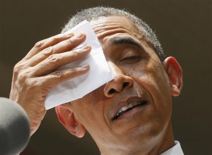 U.S. President Obama wipes his brow while he speaks about his vision to reduce carbon pollution in Washington