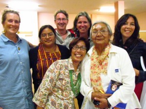 Speakers and KAIROS and community leaders celebrate after the event.