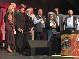 Naty Atz Sunuc is inducted with the other Honourary Witnesses and the TRC Commissioners. The sacred bentwood box is in the foreground. 
