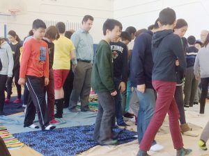 Pictured: Students and teachers in the UTS gym during the Blanket Exercise.