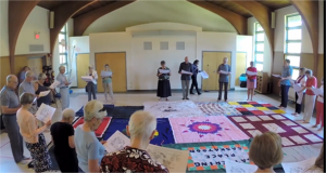 Participants partake in the Blanket Exercise, a workshop that delves into the effects of colonization. Photo by KAIROS Canada