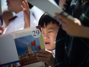 Jason Tian, 7, from China, reads along with the French language portion while taking the oath of citizenship with his brother and mom during a special Canada Day citizenship ceremony in West Vancouver, B.C., on Saturday, July 1, 2017. DARRYL DYCK / THE CANADIAN PRESS