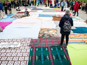 In the blanket exercise, blankets represent land belonging to Indigenous people prior to contact. As the game goes on, the blankets become smaller, with large distances between them.