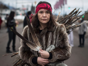 Kumgayaz Dennis, a Dakelh woman from the Lheidli T'enneh First Nation carries wood to be burned in a sacred fire in support of the Wet'suwet'en Nation protest against a BC natural gas pipeline. Photograph The Canadian Press - Darryl Dyck