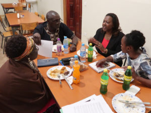 James of SSCC and Jeannette and Monica of FECCLAHA discussing WPS program narrative reporting issues at dinner during the ENSS