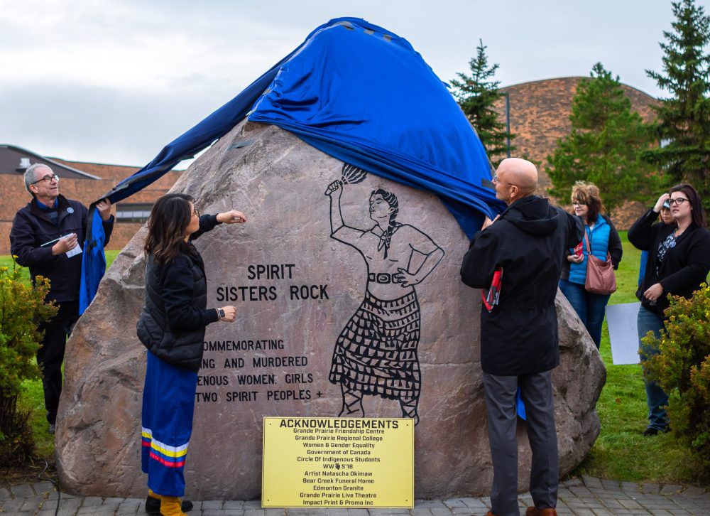 Miranda Laroche (left) assists other speakers at the ceremony reveal of the monument. The ceremony, which also saw the monument blessed, was in line with the national day of remembrance for MMIWG. Photo: John Watson / Daily Herald-Tribune