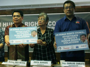 Philippine activists holding signs