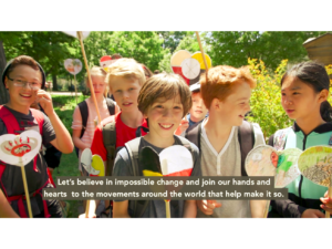 children in heart garden with text "Let's believe in impossible change and join our hands and hearts to the movements around the world that help make it so."