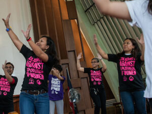 Women dance inside a Protestant church in the Philippines to dramatize calls to end discrimination against women. (Photo by Mark Saludes)