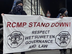 protest sign: RCMP stand down! respect Wet'suweten governance and law