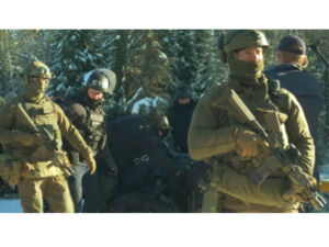 Dozens of heavily armed RCMP breaching the checkpoint during the Nov. 18 militarized raid. Credit: Dan Loan / Gidimt’en Checkpoint