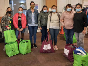 Sandy Falcon (third from left) and Liliana Higginson (end, right) from Unknown Neighbours, a ETFW Project Partner, provide support and resources to migrant workers at a weekly drop-in at Bradford Baptist Church. Photo: Unknown Neighbours.