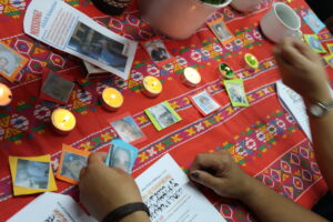 Images of human right defenders and candles on a table with decorative cloth