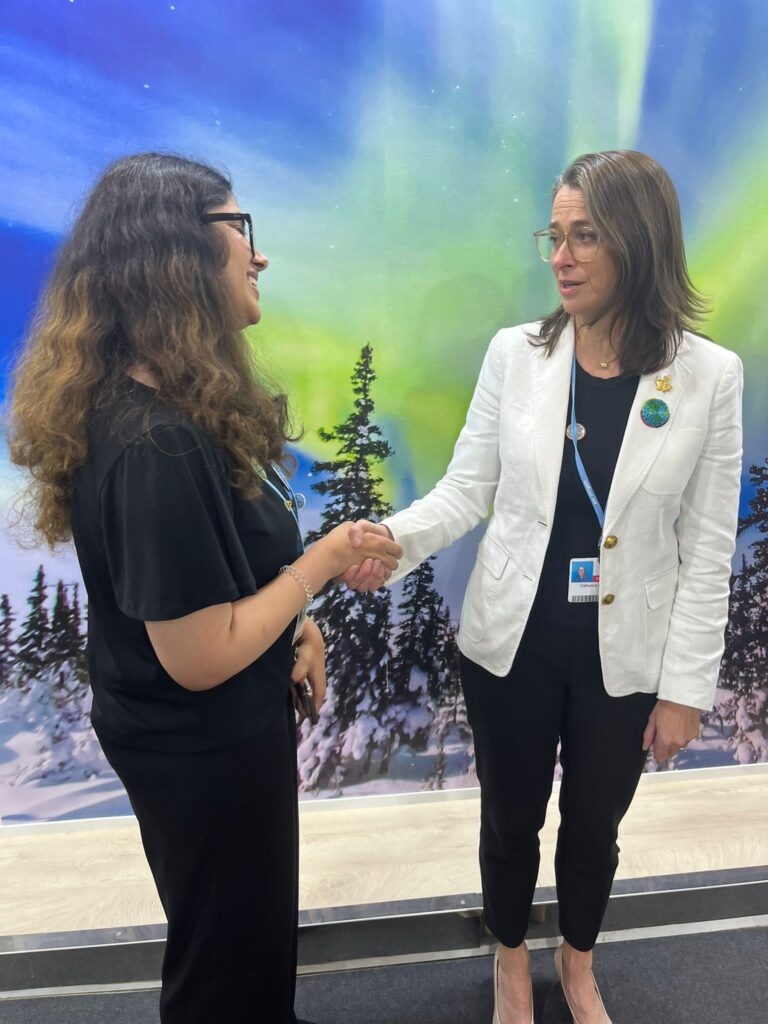Yusra greeting Canada's Climate Ambassador, Christine Stewart at COP27